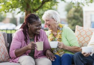 Senior woman, African-American friend laughing together