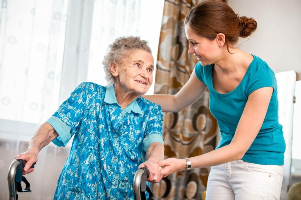 Live-in carer helping out an elderly woman