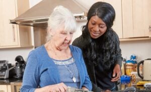 Elderly woman with live-in carer in the kitchen
