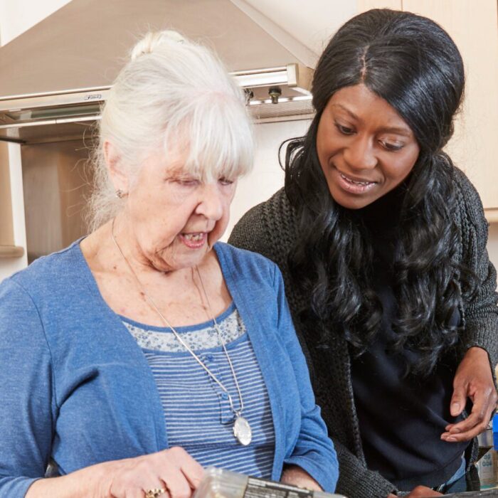 Elderly woman with live-in carer in the kitchen