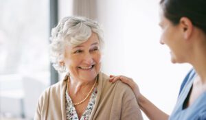 Older woman receives encouragement from Stroke nurse