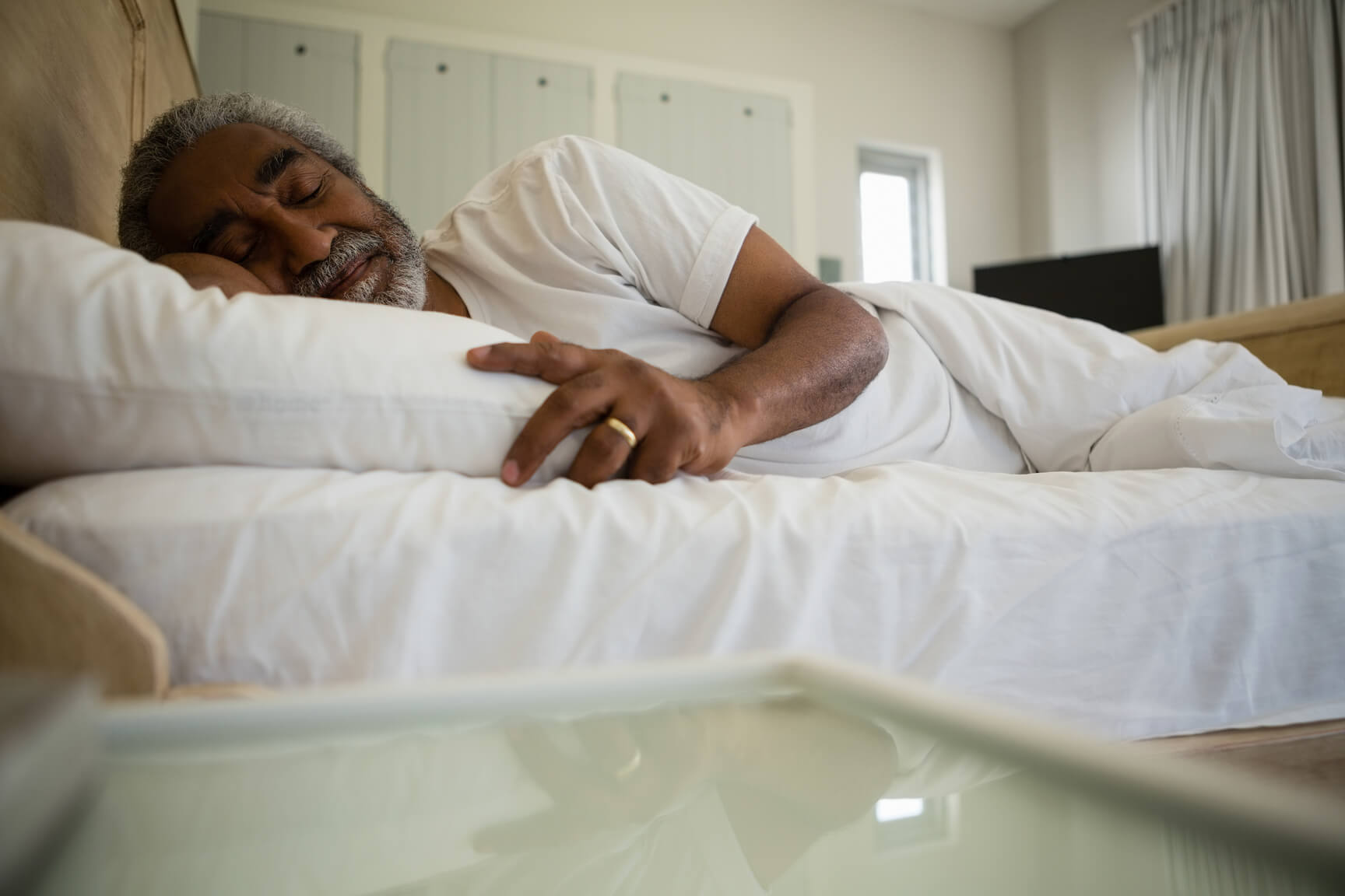 Elderly man sleeping lightly in the morning