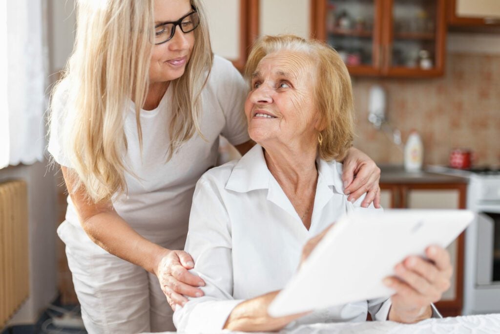 Daughter offering support to elderly parent