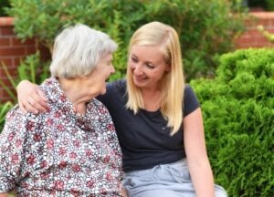 Carer with old woman affected by dementia