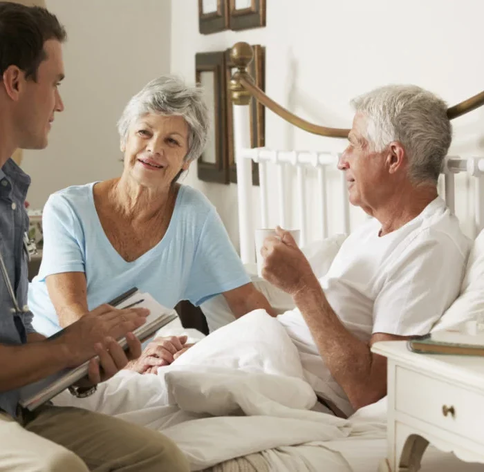 Healthcare professional talking about palliative care with the patient and their loved one