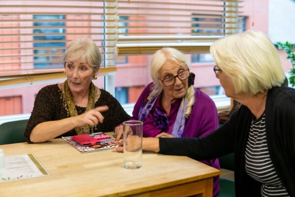 3 elderly women in a social setting