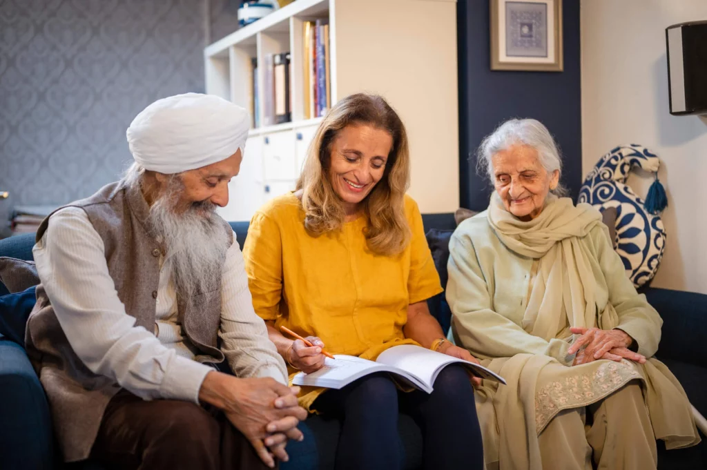 Elderly couple with their carer at home