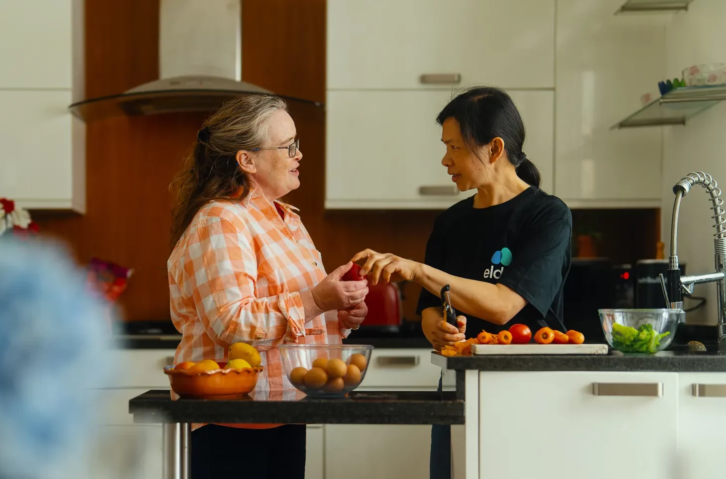 Woman with her carer in the kitchen