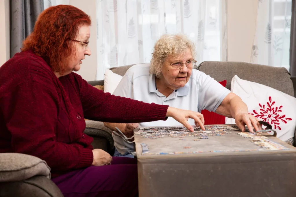 Elderly woman playing games with her carer