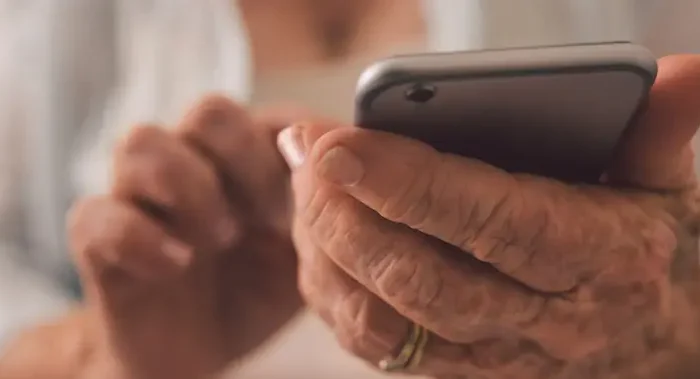 Senior person holding a phone